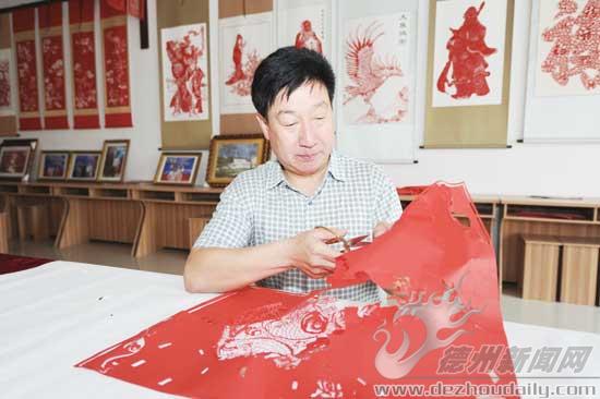 張長俊進行剪紙創(chuàng)作。